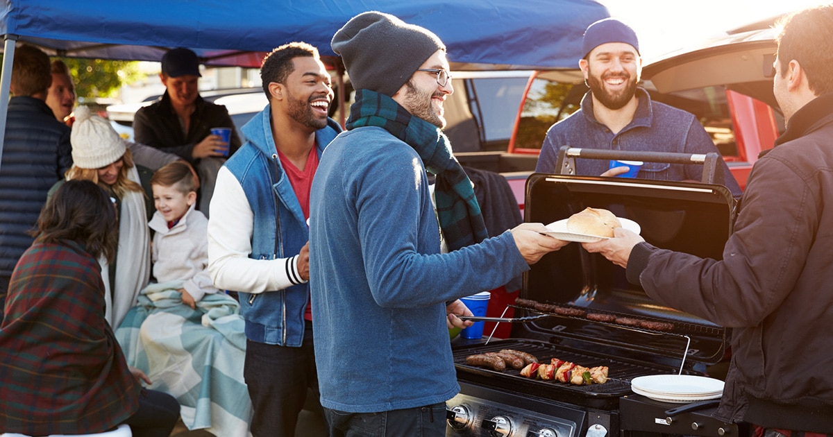 People gather at a football tailgate